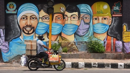 A motorist passes by a mural of frontline workers against coronavirus. (Sanchit Khanna / HT Photo) A motorist passes by a mural of frontline workers against coronavirus. (Sanchit Khanna / HT Photo)