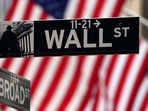 A Wall Street sign is pictured outside the New York Stock Exchange.