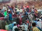 Migrants deboard an overcrowded bus after it overturned and lost balance in Gwalior district on Tuesday.