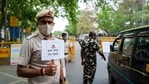 Policemen guarding a roadblock in New Delhi on April 20 as the national capital enters a week-long lockdown in light of rising Covid-19 cases. (AFP) Policemen guarding a roadblock in New Delhi on April 20 as the national capital enters a week-long lockdown in light of rising Covid-19 cases. (AFP)