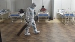 A doctor drags an oxygen cylinder at the CWG Village Covid-19 Care Centre on Tuesday.(PTI) A doctor drags an oxygen cylinder at the CWG Village Covid-19 Care Centre on Tuesday.(PTI)