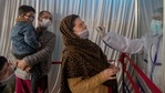 A health worker takes a nasal swab sample of a Kashmiri woman to test for COVID-19 as her family members watch in Srinagar, Indian-controlled Kashmir, Thursday, April 15, 2021. India's two largest cities imposed stringent restrictions on movement and one planned to use hotels and banquet halls to treat coronavirus patients amid a devastating surge that is straining a fragile health system. (AP Photo/ Dar Yasin)(AP) A health worker takes a nasal swab sample of a Kashmiri woman to test for COVID-19 as her family members watch in Srinagar, Indian-controlled Kashmir, Thursday, April 15, 2021. India's two largest cities imposed stringent restrictions on movement and one planned to use hotels and banquet halls to treat coronavirus patients amid a devastating surge that is straining a fragile health system. (AP Photo/ Dar Yasin)(AP)