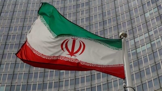 An Iranian flag flutters in front of the International Atomic Energy Agency (IAEA) headquarters in Vienna, Austria.(Reuters)