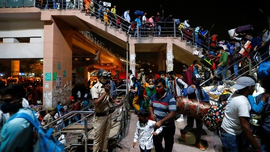 Large number of people mostly migrants gathered at bus stands after Delhi imposed weeklong lockdown to contain spread of coronavirus cases.