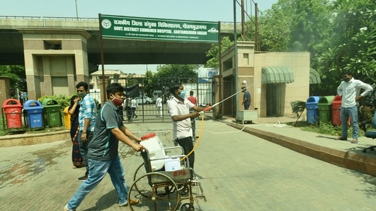 Health workers sanitize the premises of a district hospital at sector 30, in Noida, India, on Monday, April 19, 2021. (Sunil Ghosh / Hindustan Times) Health workers sanitize the premises of a district hospital at sector 30, in Noida, India, on Monday, April 19, 2021. (Sunil Ghosh / Hindustan Times)