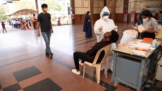 So far, 24,341,736 Covid-19 tests have been conducted in the state. In picture - Medics take swab sample for Covid-19 test at Kopar Khairane Railway Station in Navi Mumbai. (HT Photo)