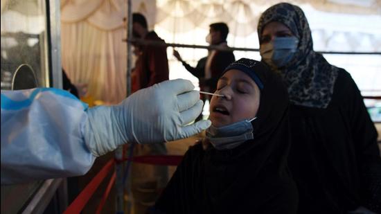 A health worker takes a nasal swab sample of a girl to test for COVID-19 at a test center in Srinagar,17 April 2021. (Photo by Waseem Andrabi/Hindustan Times) A health worker takes a nasal swab sample of a girl to test for COVID-19 at a test center in Srinagar,17 April 2021. (Photo by Waseem Andrabi/Hindustan Times)