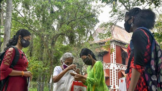 File photo: An elderly woman pumps sanitizer on the hands of a student before entering the premises of a university in Thiruvananthapuram. (PTI) File photo: An elderly woman pumps sanitizer on the hands of a student before entering the premises of a university in Thiruvananthapuram. (PTI)