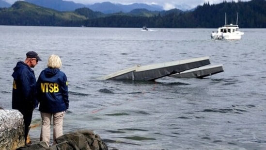 NTSB investigator Clint Crookshanks and member Jennifer Homendy stand near the site of some of the wreckage of the DHC-2 Beaver. (AP) NTSB investigator Clint Crookshanks and member Jennifer Homendy stand near the site of some of the wreckage of the DHC-2 Beaver. (AP)
