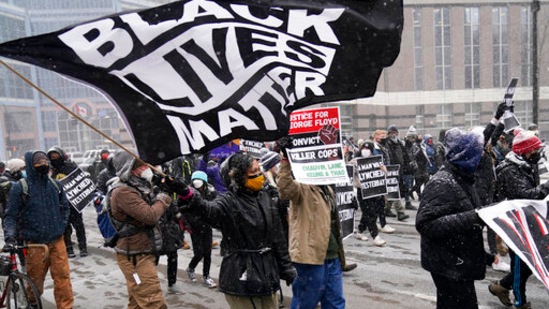 A group of protesters march in the snow around the Hennepin County Government Center. (AP Photo/Jim Mone) A group of protesters march in the snow around the Hennepin County Government Center. (AP Photo/Jim Mone)