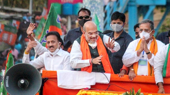 South Dinajpur: Union Home Minister and BJP leader Amit Shah during a roadshow in support of party candidates for the West Bengal Assembly Polls at Balurghat in South Dinajpur district, Monday, April 19, 2021. (PTI) South Dinajpur: Union Home Minister and BJP leader Amit Shah during a roadshow in support of party candidates for the West Bengal Assembly Polls at Balurghat in South Dinajpur district, Monday, April 19, 2021. (PTI)