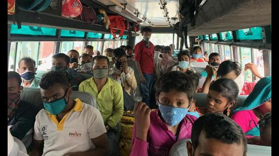 Migrants inside a bus bound for Uttar Pradesh, in Jalandhar on Tuesday. (HT Photo) Migrants inside a bus bound for Uttar Pradesh, in Jalandhar on Tuesday. (HT Photo)