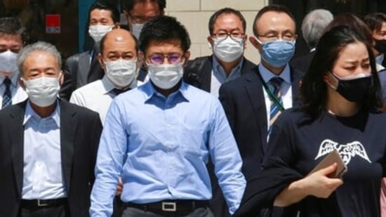 People wearing face masks to protect against the spread of the coronavirus walk on a street in Tokyo on April 20, 2021. (AP) People wearing face masks to protect against the spread of the coronavirus walk on a street in Tokyo on April 20, 2021. (AP)