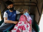 A Covid-19 patient waits inside an autorickshaw to be attended to and admitted into a hospital in Ahmedabad on Saturday.(AP Photo ) A Covid-19 patient waits inside an autorickshaw to be attended to and admitted into a hospital in Ahmedabad on Saturday.(AP Photo )