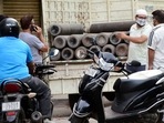 People enquire about availability of cylinders of medical oxygen, required for treatment of critical Covid-19 patients, in New Delhi on Wednesday.