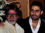 Bollywood actors Amitabh Bachchan (L) and his son Abhishek Bachchan pose for a picture during a party.(REUTERS)