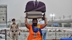 Migrant woman carries belongings on her head as she arrives at Anand Vihar Bus Terminal after Delhi Government announced a complete lockdown for 6 days.(ANI Photo ) Migrant woman carries belongings on her head as she arrives at Anand Vihar Bus Terminal after Delhi Government announced a complete lockdown for 6 days.(ANI Photo )