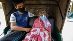 A Covid-19 patient waits inside an autorickshaw to be attended to and admitted into a hospital in Ahmedabad on Saturday.(AP Photo ) A Covid-19 patient waits inside an autorickshaw to be attended to and admitted into a hospital in Ahmedabad on Saturday.(AP Photo )