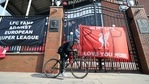A man cycles past banners outside of Anfield Stadium, Liverpool, England protesting against the clubs decision to join the European Super Leaguer, Tuesday April 20, 2021.(AP) A man cycles past banners outside of Anfield Stadium, Liverpool, England protesting against the clubs decision to join the European Super Leaguer, Tuesday April 20, 2021.(AP)