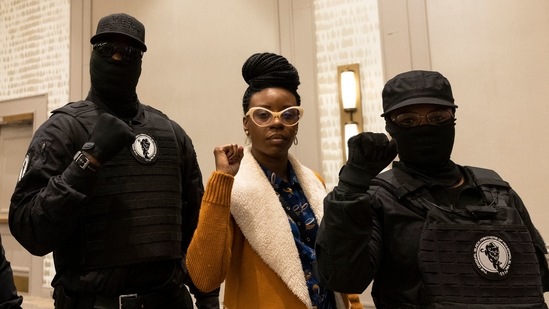 George Floyd's cousin's daughter Tedra McGee (C) poses with members of The Original Black Panthers of Minnesota after a press conference following the verdict in the trial in Minneapolis on April 20. In a trial that opened on March 29, the defense argued that Chauvin behaved as any "reasonable police officer" would have under those circumstances, and sought to raise doubts about the cause of Floyd's death.(Kerem Yucel / AFP)