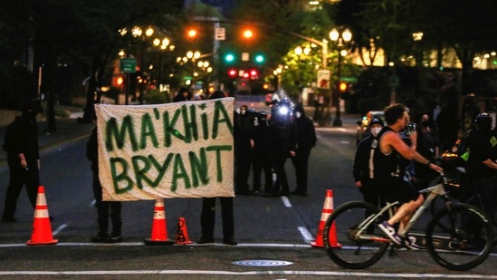 Protesters hold a sign with the name of Ma'Khia Bryant, who was fatally shot by a police officer in Columbus, Ohio. (Reuters)