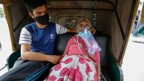 A Covid-19 patient waits inside an autorickshaw to be attended to and admitted into a hospital in Ahmedabad on Saturday.(AP Photo )