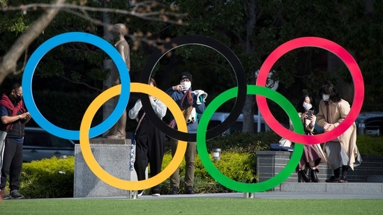 People take pictures of the Olympic rings installed by the Japan Olympic Museum in Tokyo.(AP) People take pictures of the Olympic rings installed by the Japan Olympic Museum in Tokyo.(AP)