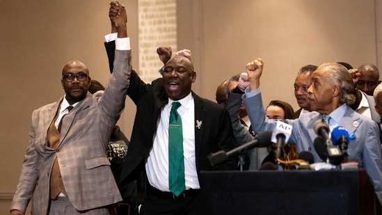 Philonise Floyd (L), Attorney Ben Crump (C) and Reverend Al Sharpton (R) react following the verdict in Minneapolis on April 20. George Floyd's brother Philonise, speaking at a news conference with several family members, said: "We are able to breathe again" after the verdict, but he added the fight for justice was not over.(Kerem Yucel / AFP)