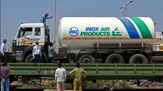 An oxygen tanker is being boarded on a special train called 'Oxygen Express' that will transport the public health commodity to states grappling with the second wave of the Covid-19 pandemic. (AFP PHOTO.) An oxygen tanker is being boarded on a special train called 'Oxygen Express' that will transport the public health commodity to states grappling with the second wave of the Covid-19 pandemic. (AFP PHOTO.)