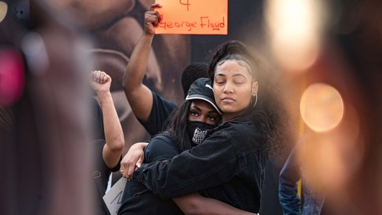 Hannah Gebresilassie (L) and Qri Montague (R) embrace before joining other people marching through the streets after the verdict was announced for Derek Chauvin on April 20 in Atlanta, Georgia(Megan Varner / Getty Images / AFP)
