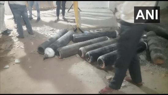 Oxygen cylinders lay strewn about after a group of unidentified people stole oxygen cylinders from a hospital in Madhya Pradesh's Damoh on Wednesday.(ANI/Twitter)
