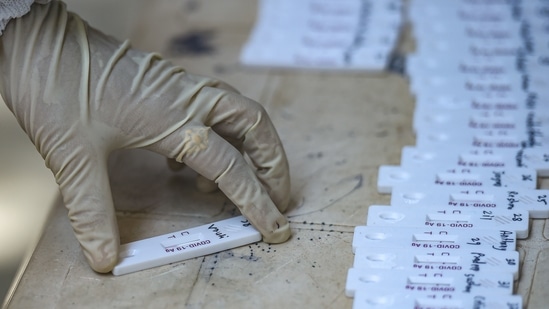 A medic sorts swab samples for Covid-19 testing at a hospital in Mumbai on Monday. (PTI Photo ) A medic sorts swab samples for Covid-19 testing at a hospital in Mumbai on Monday. (PTI Photo )