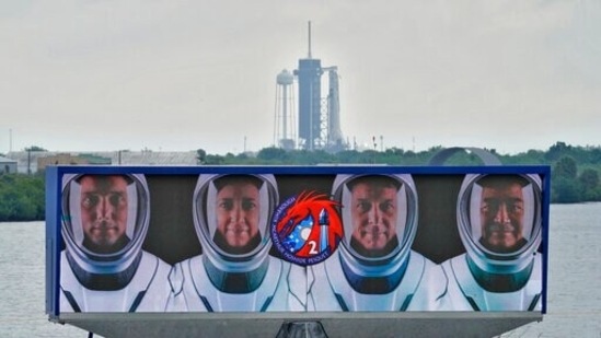 Members of the SpaceX Crew 2 are shown on a video screen as the SpaceX Falcon 9 with the Dragon capsule sits on Launch Complex 39A.(AP)