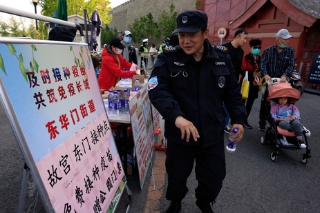 A security guard receives a sticker declaring he is vaccinated against the coronavirus at a stand promoting free shots outside an entrance to the Forbidden City in Beijing. (AP Photo) A security guard receives a sticker declaring he is vaccinated against the coronavirus at a stand promoting free shots outside an entrance to the Forbidden City in Beijing. (AP Photo)