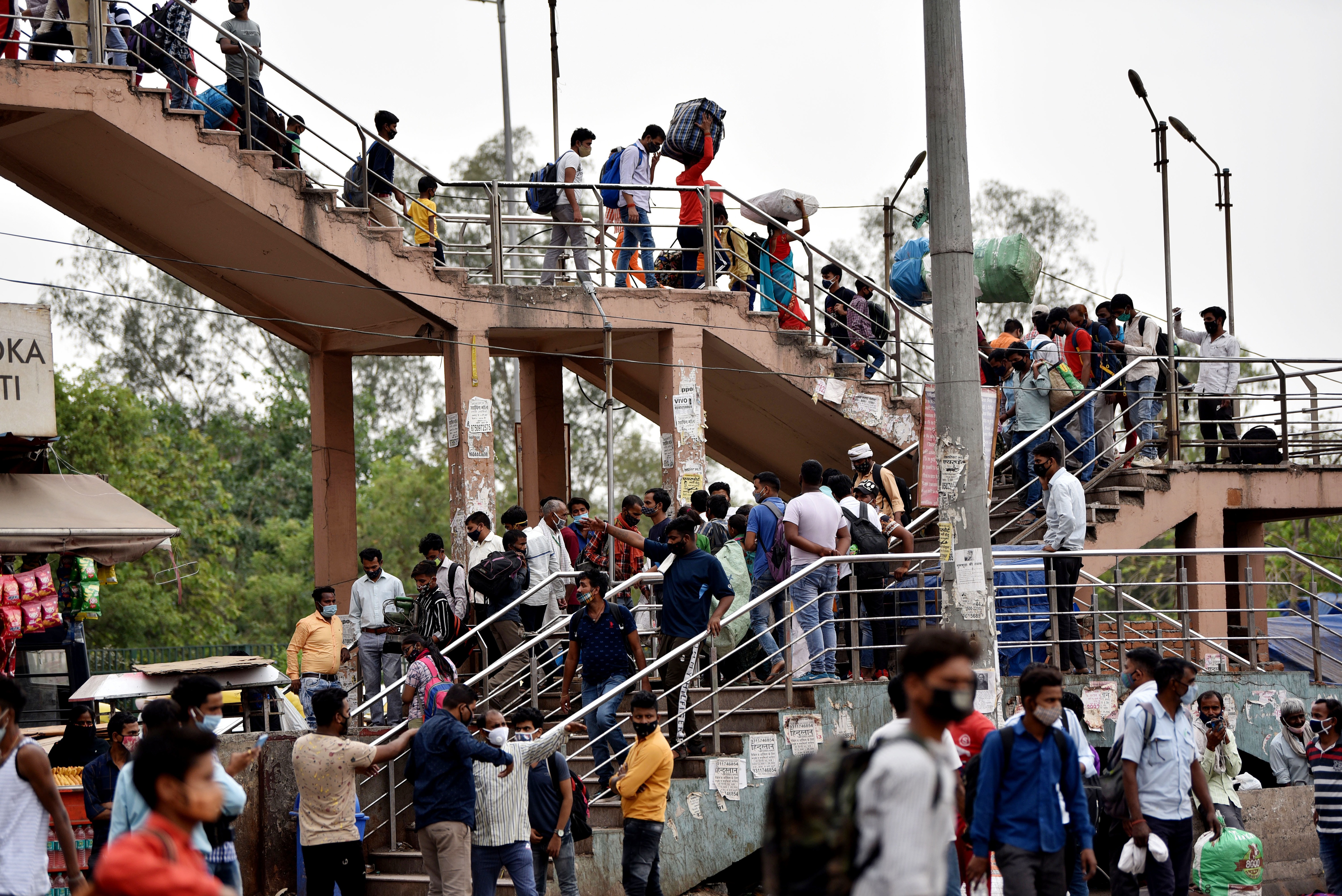 Migrant workers arrive to board the bus for their hometown after the 6-day lockdown imposed by Delhi government (ANI Photo) Migrant workers arrive to board the bus for their hometown after the 6-day lockdown imposed by Delhi government (ANI Photo)