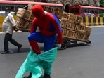 Social worker Ashok Kurmi, dressed as superhero Spiderman, puts on a PPE at Chhatrapati Shivaji Maharaj Terminus, amid the sharp spike in coronavirus cases, in Mumbai, on April 21. India recorded 315,909 new cases of coronavirus disease (Covid-19) on April 21 breaking not only all its previous daily records but also earned the grim distinction of reporting the most single-day infections in any country ever.(Bhushan Koyande / HT Photo)