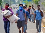 Migrants walk on the road after their arrival from Chhattisgarh via-Raipur, in Ranchi for their native places in Jharkhand, amid a rise in Covid-19 cases across the country, in Ranchi, on Wednesday. April 21, 2021. (PTI) Migrants walk on the road after their arrival from Chhattisgarh via-Raipur, in Ranchi for their native places in Jharkhand, amid a rise in Covid-19 cases across the country, in Ranchi, on Wednesday. April 21, 2021. (PTI)