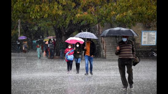 People caught in the hailstorm at the Ridge in Shimla on Thursday. (Deepak Sansta/HT) People caught in the hailstorm at the Ridge in Shimla on Thursday. (Deepak Sansta/HT)