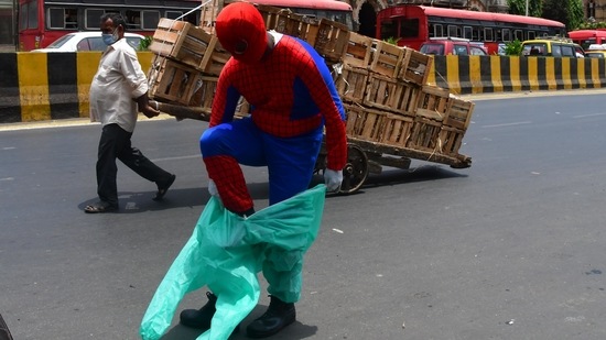 Social worker Ashok Kurmi, dressed as superhero Spiderman, puts on a PPE at Chhatrapati Shivaji Maharaj Terminus, amid the sharp spike in coronavirus cases, in Mumbai, on April 21. India recorded 315,909 new cases of coronavirus disease (Covid-19) on April 21 breaking not only all its previous daily records but also earned the grim distinction of reporting the most single-day infections in any country ever.(Bhushan Koyande / HT Photo)