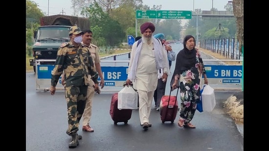 Sikh pilgrims crossing over to India through the Attari-Wagah border on Thursday. (HT Photo)