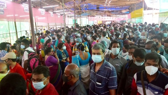 Polling officials, election workers, and presiding officers stand in queues flouting social distance at EVM distribution center on the eve of the 6th phase of the West Bengal assembly election at Barrackpore, in North 24 Parganas on Wednesday. (ANI photo)