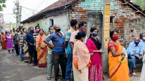 Voters stand in a queue to cast their votes during the sixth phase of West Bengal Assembly Election, in North 24 Paraganas on Thursday. (ANI Photo)