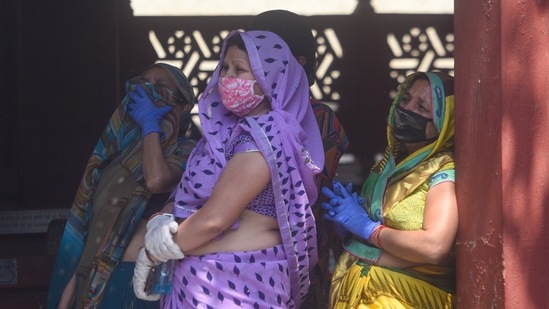 Relatives of Covid-19 victim react during the cremation, at Nigambodh Ghat crematorium, in New Delhi, on April 21. A total of 2,102 people lost their lives to the viral disease across India on April 21, also the single-day record for the country.(Amal KS / HT Photo)