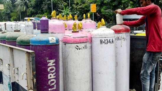 A worker loads oxygen cylinder to distribute to hospitals amid rising Covid cases. (ANI Photo) A worker loads oxygen cylinder to distribute to hospitals amid rising Covid cases. (ANI Photo)