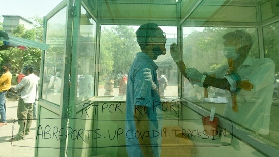 A health worker collects a swab sample from a man for a Covid-19 test, at District Hospital, in Sector 30, Noida, on April 21. 15,924,697 confirmed Covid-19 infections and 184,693 deaths have now been reported across India until April 21, HT reported.(Sunil Ghosh / HT Photo)
