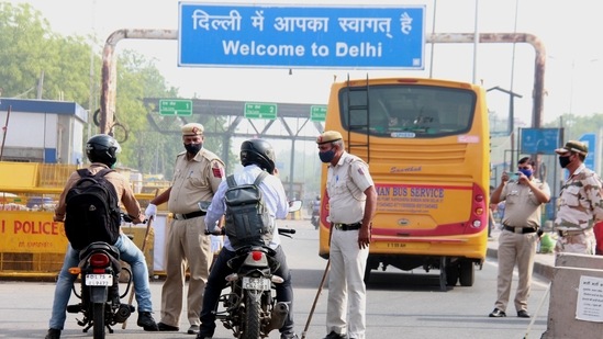 Delhi Police personnel check lockdown passes for commuters at Dundahera-Kapashera border after AAP government announced complete lockdown for 6 days due to surge in Covid-19 cases, in Gurugram. (PTI Photo) Delhi Police personnel check lockdown passes for commuters at Dundahera-Kapashera border after AAP government announced complete lockdown for 6 days due to surge in Covid-19 cases, in Gurugram. (PTI Photo)