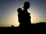 An Ethiopian woman who fled the ongoing fighting in Tigray region, carries her child near the Setit river on the Sudan-Ethiopia border in Hamdayet village in eastern Kassala state, Sudan. (REUTERS) An Ethiopian woman who fled the ongoing fighting in Tigray region, carries her child near the Setit river on the Sudan-Ethiopia border in Hamdayet village in eastern Kassala state, Sudan. (REUTERS)