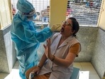 A Medic in PPE takes swab samples from a health worker for RT-PCR at a government hospital in New Delhi.(ANI) A Medic in PPE takes swab samples from a health worker for RT-PCR at a government hospital in New Delhi.(ANI)