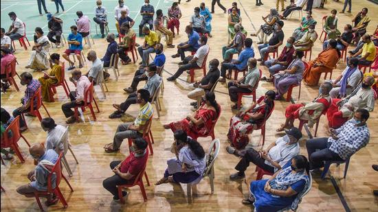 Beneficiaries wait at a health centre to receive the dose of Covid-19 vaccine, in Guwahati on Thursday, April 22. (PTI)