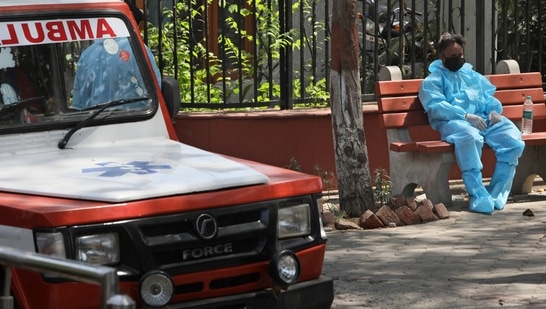 A health worker sits on a bench after helping cremating victims of coronavirus, in New Delhi. A health worker sits on a bench after helping cremating victims of coronavirus, in New Delhi.